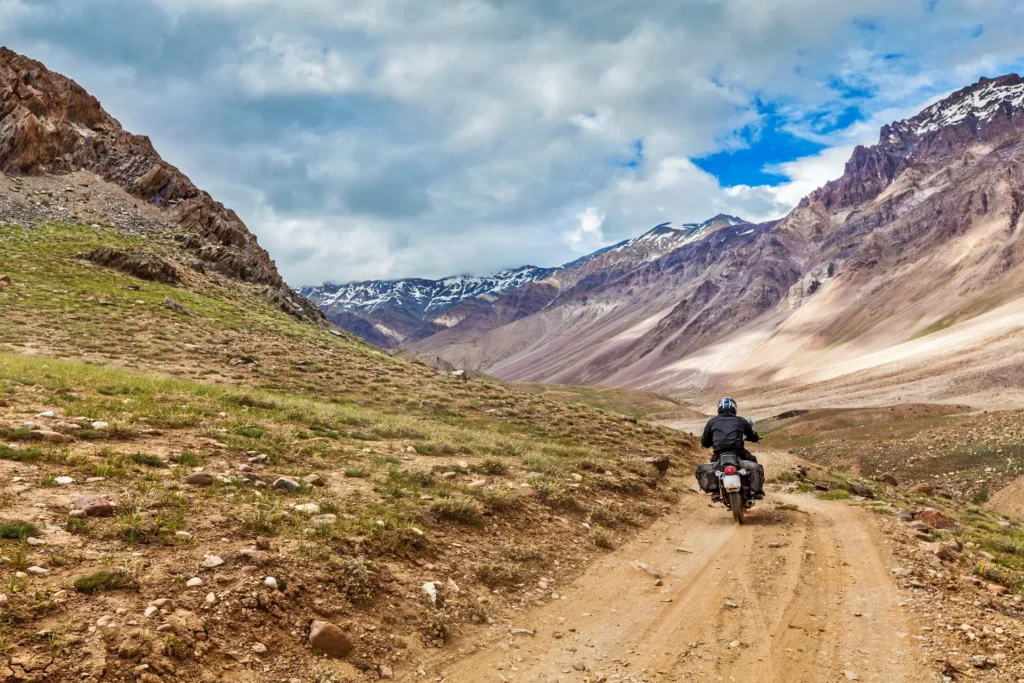 A man riding a bike on the rough roads of Ladakh